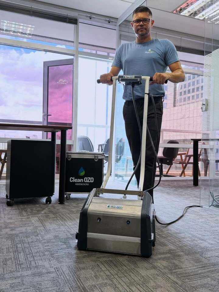 Profissional da Clean Ozo higienizando carpete com equipamento Rainbow em escritório de São Paulo